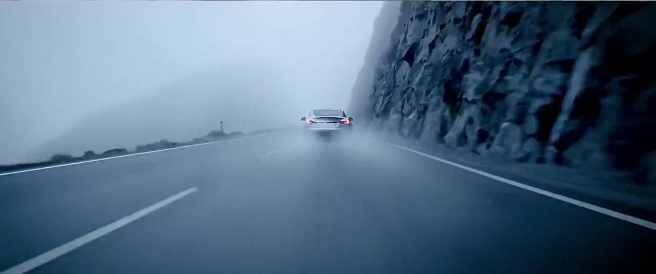 Final frame: Tesla ascending a misty mountain road