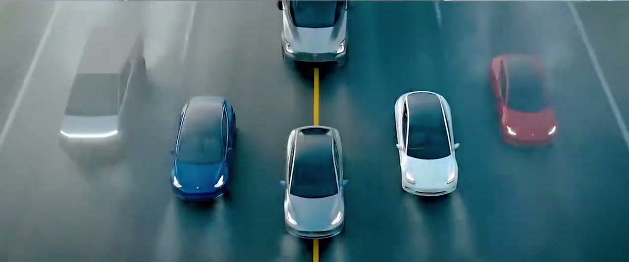 Final frame: Tesla fleet forming on the road, aerial view